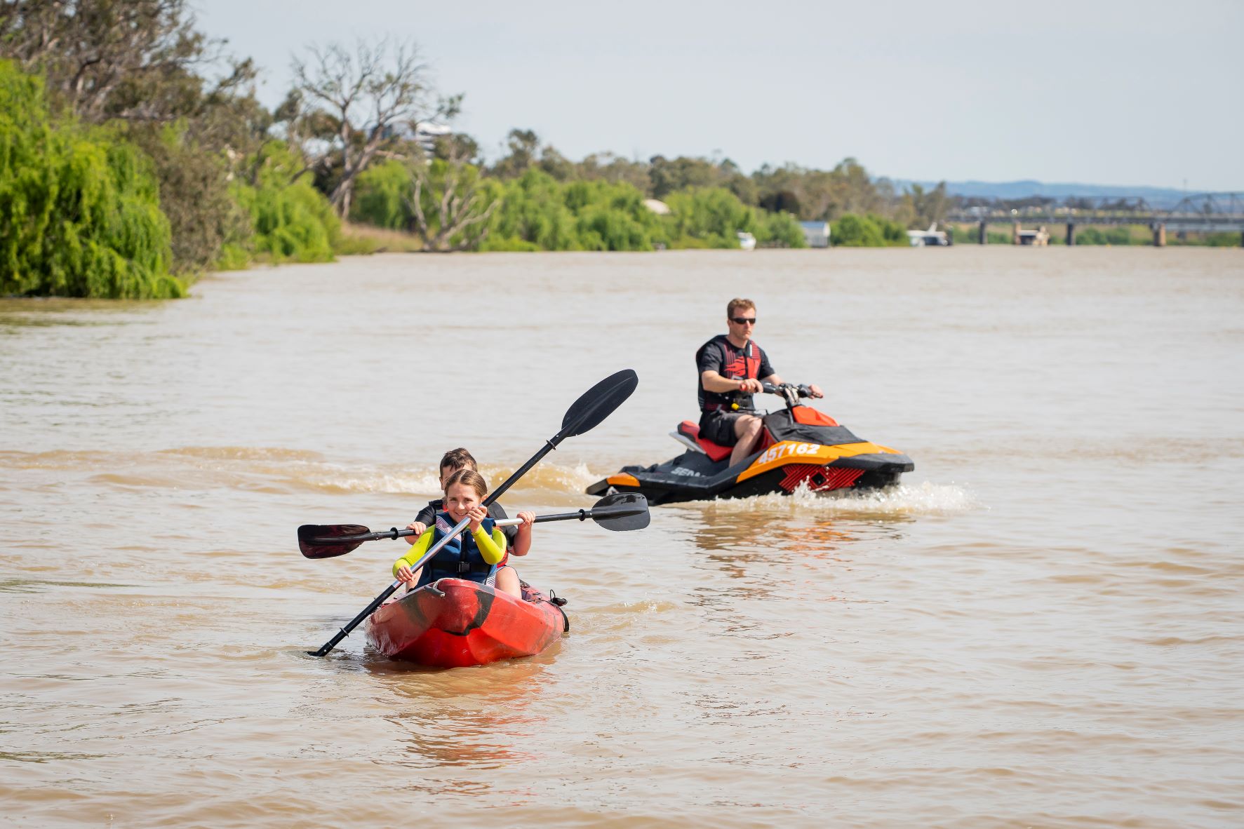 Jetski doing 4 knots on the river near 2 children kayaking