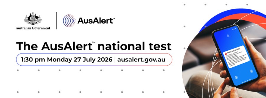 The image is a promotional banner for the Australian Government's AusAlert emergency warning system. The banner features the Australian Government crest and the AusAlert logo at the top. Large bold text in the centre reads &ldquo;The AusAlert national test&rdquo;.  Below the heading, the banner states that the national test will occur at 1:30 pm on Monday 27 July 2026 and directs readers to ausalert.gov.au for more information.  On the right-hand side of the image, a smartphone is shown displaying a sample emergency alert message on a blue screen. Curved red, blue and white graphic elements surround the phone, representing communication and alert networks. The background is light grey with a subtle pattern of small dots.  The image promotes the upcoming national test of Australia's emergency alert system, which is designed to send warnings and emergency information to mobile devices during significant incidents and disasters.