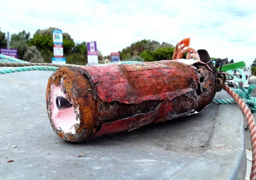 Rusted and damaged red fire extinguisher