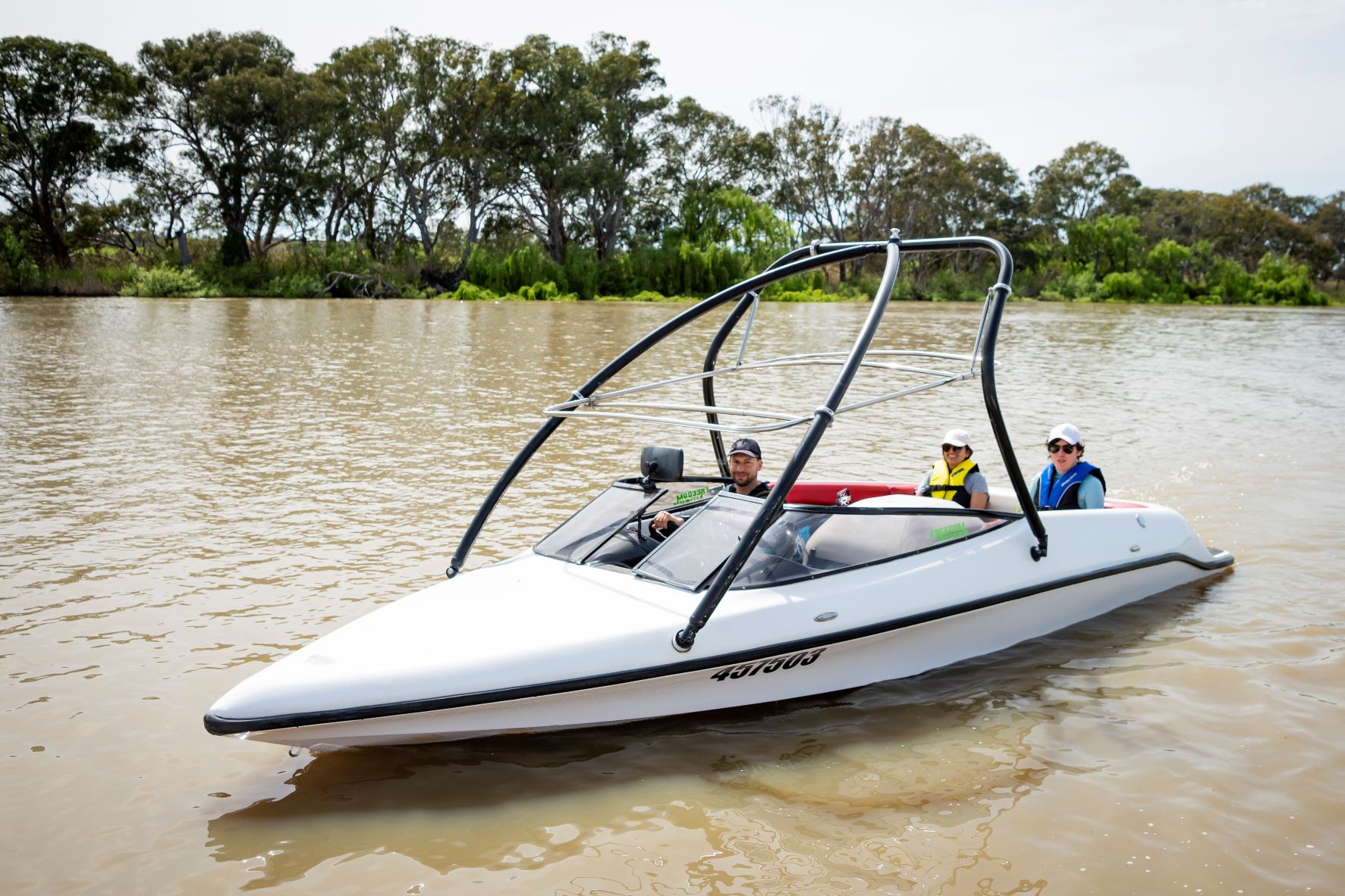 Ski boat on the River Murray with three people on board