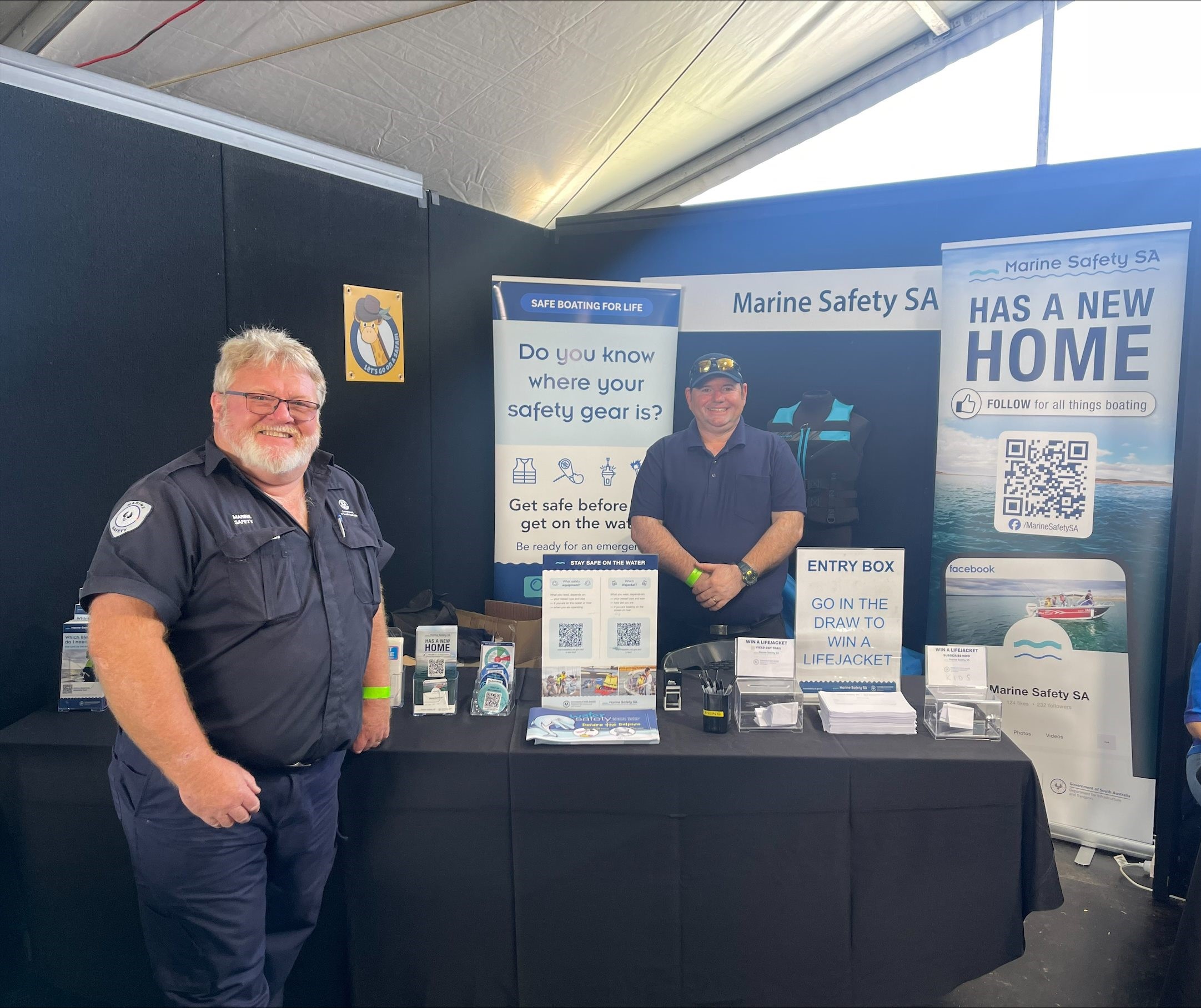 Marine Safety SA gentlemen smiling for a photo in front of Marine Safety