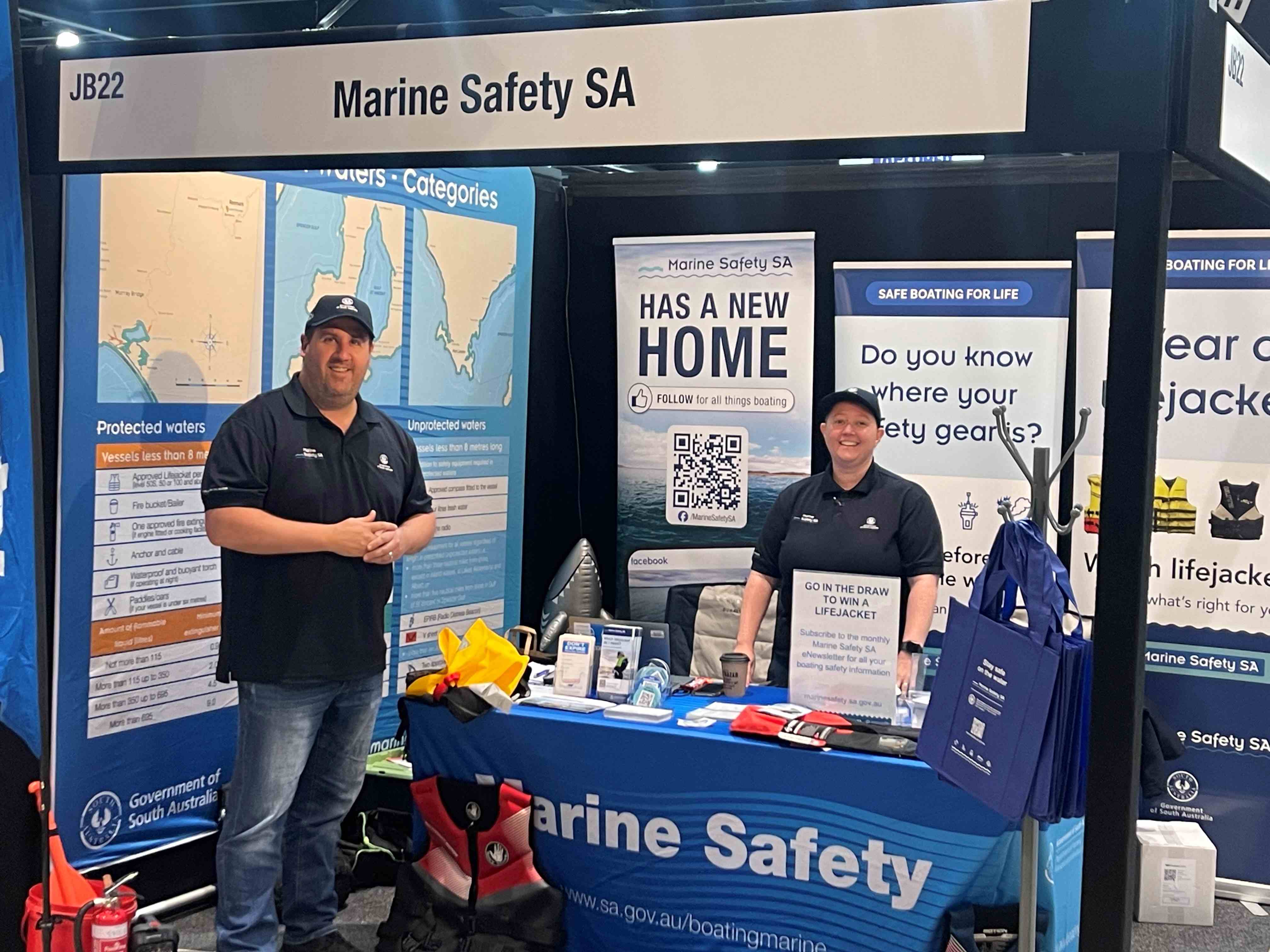 Photo of two Marine Safety staff at the $WD and boat show standing at our educational stand