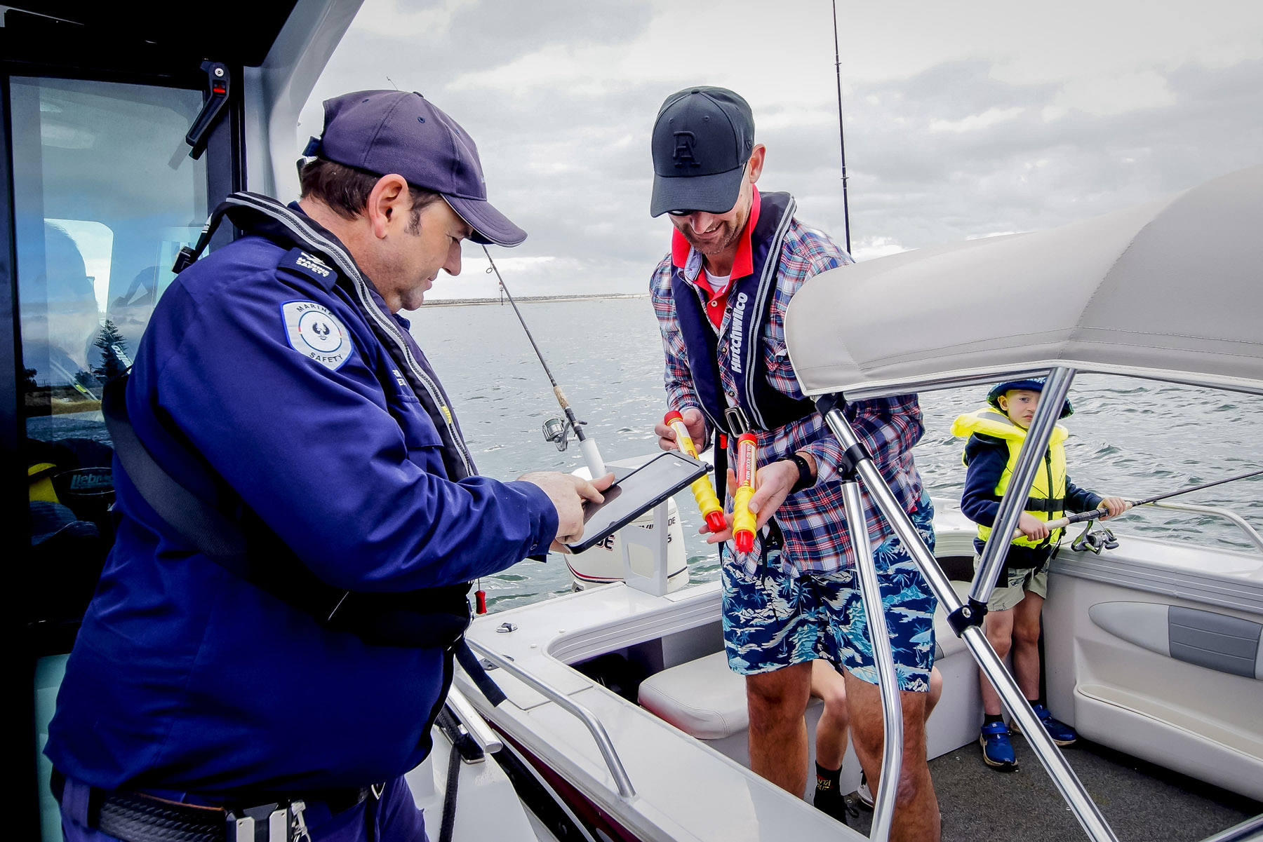 Marine Safety Officer checking the flares of a male on a boat