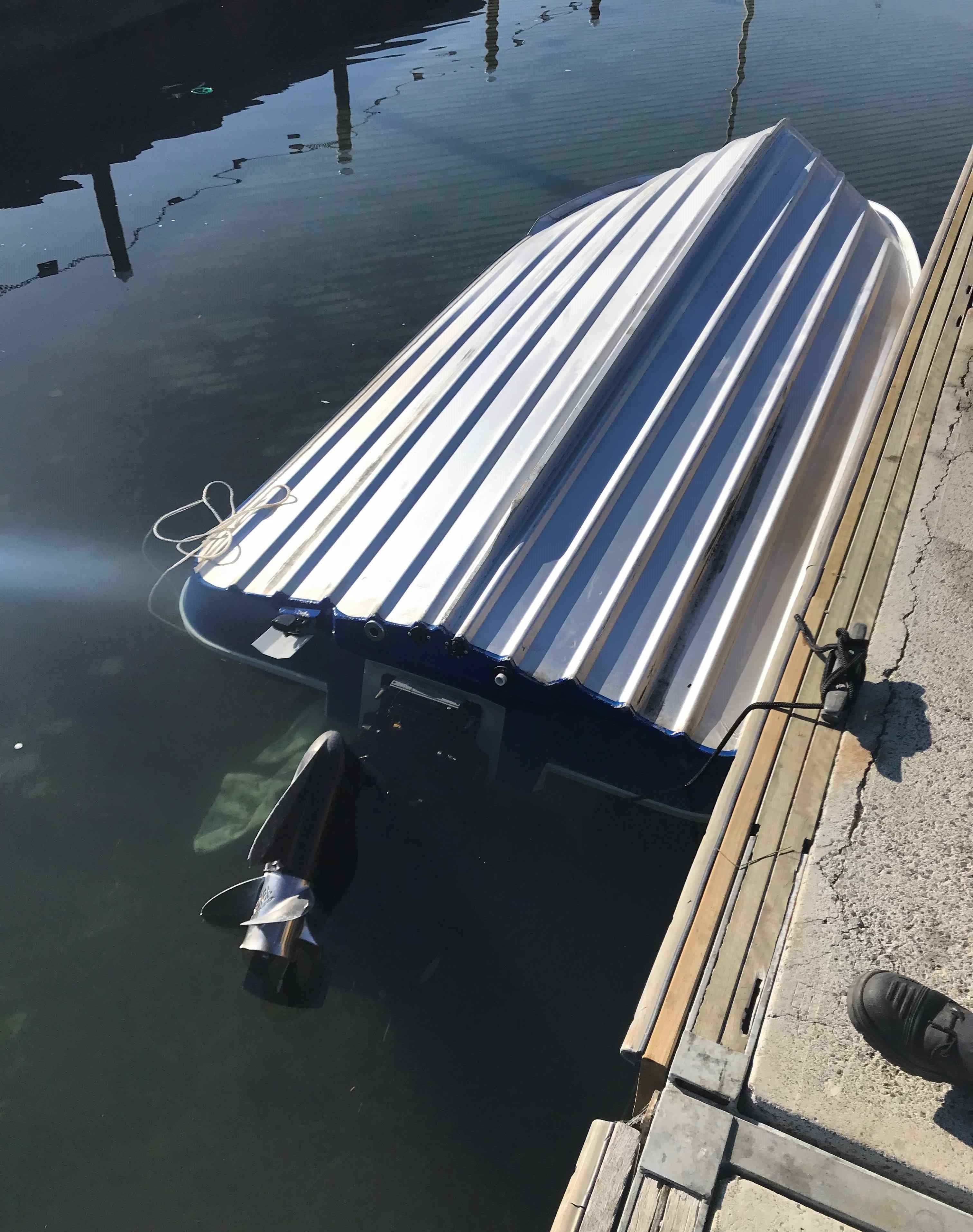 A tin vessel upside down in the water due to not having the bungs in properly