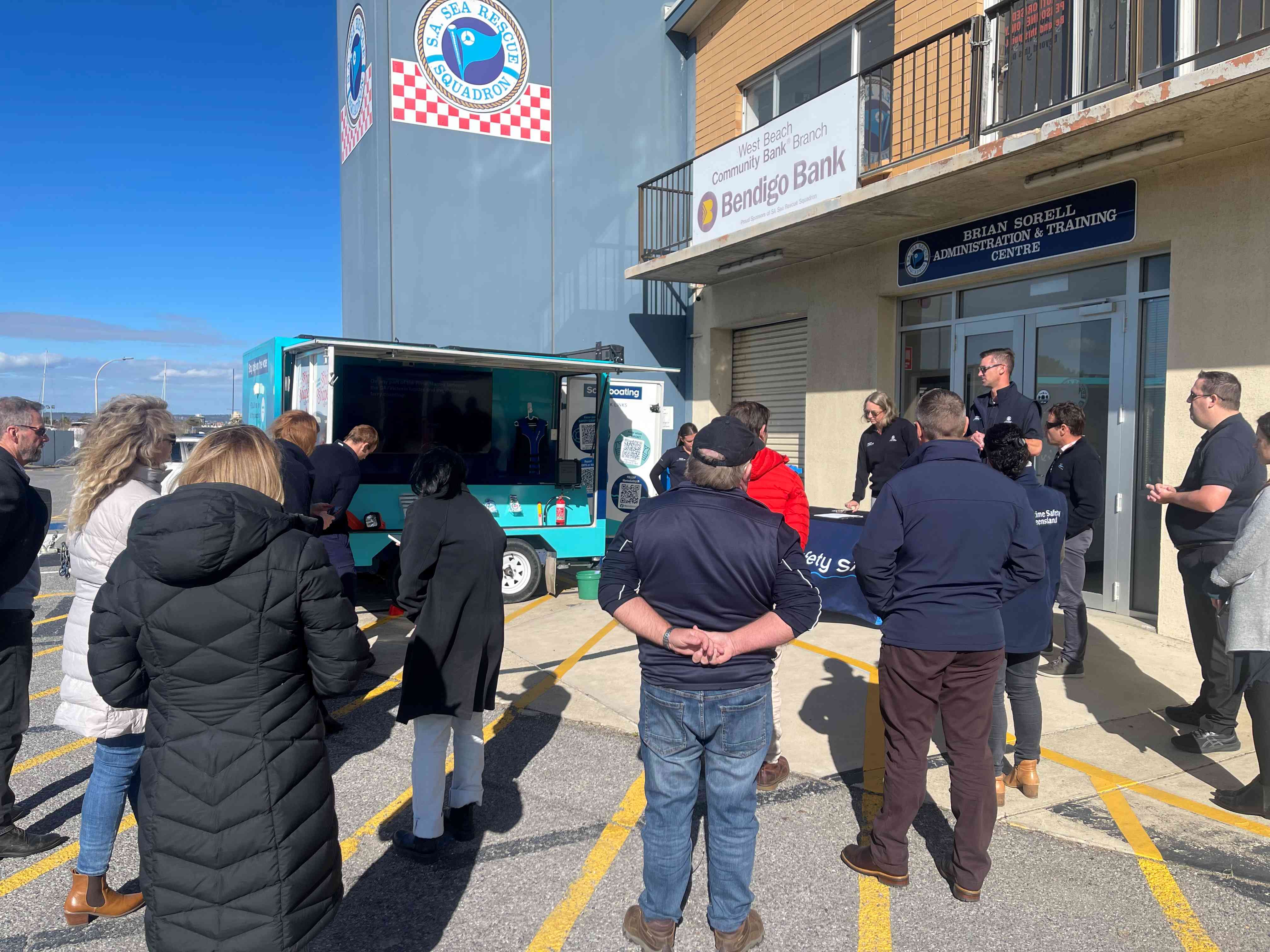 Pictured is Marine Safety Educational Trailer with members from Australia New Zeland Safe Boating Education Group. The members pictured are all facing towards the trailer while Marine Safety SA Team spoke and explained how we use our Educational Trailer when conducting Stay Afloat Clinics.